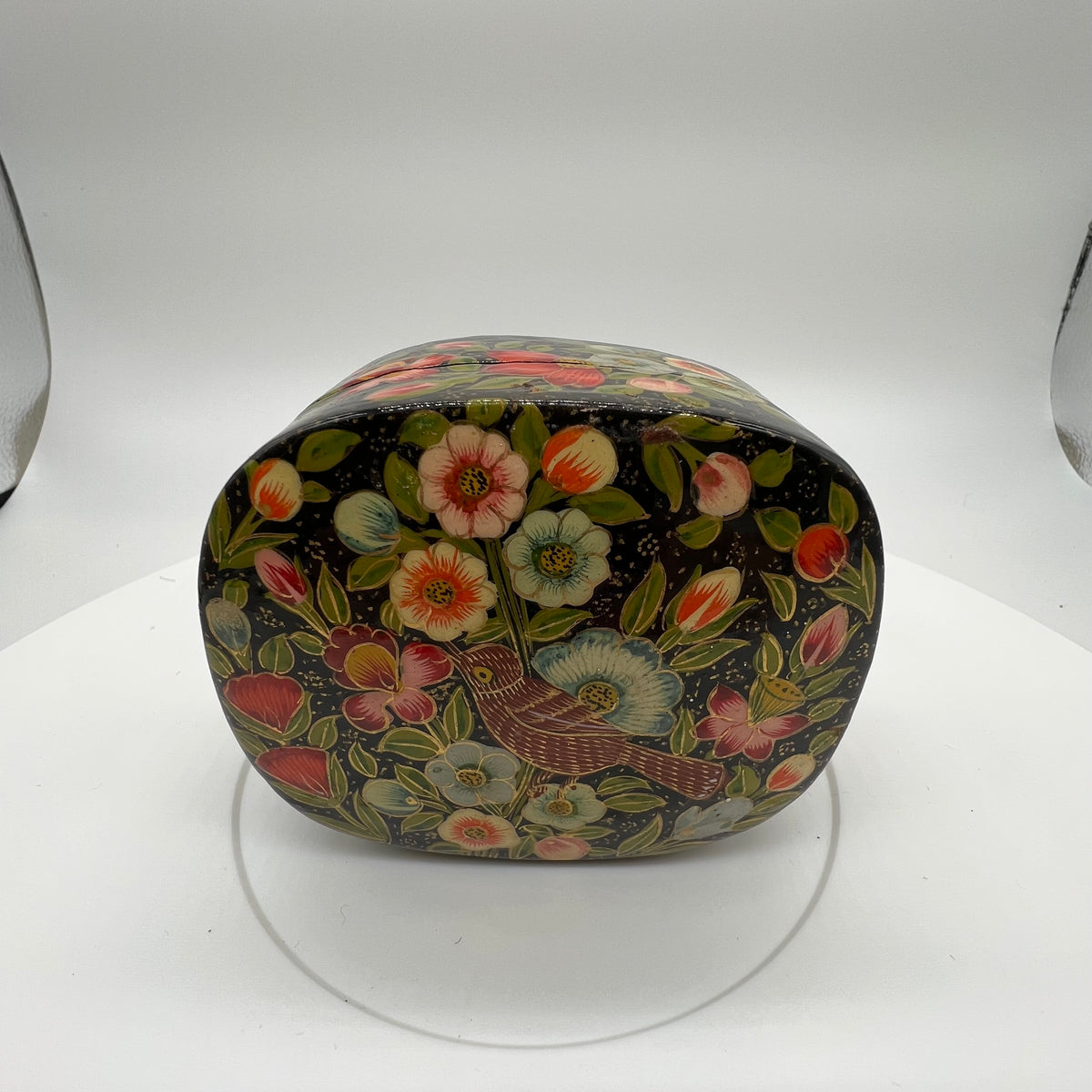 Lovely and finely detailed hand-painted Kashmiri paper cache trinket box. Features flowers, leaves and a bird on a black background.All sides and top of box are painted. 