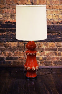A stunning and unusual mid-century pottery lamp. The lamp has a lovely vermilion glaze and interesting shape.  reminiscent of works by Raymor and Bitossi.