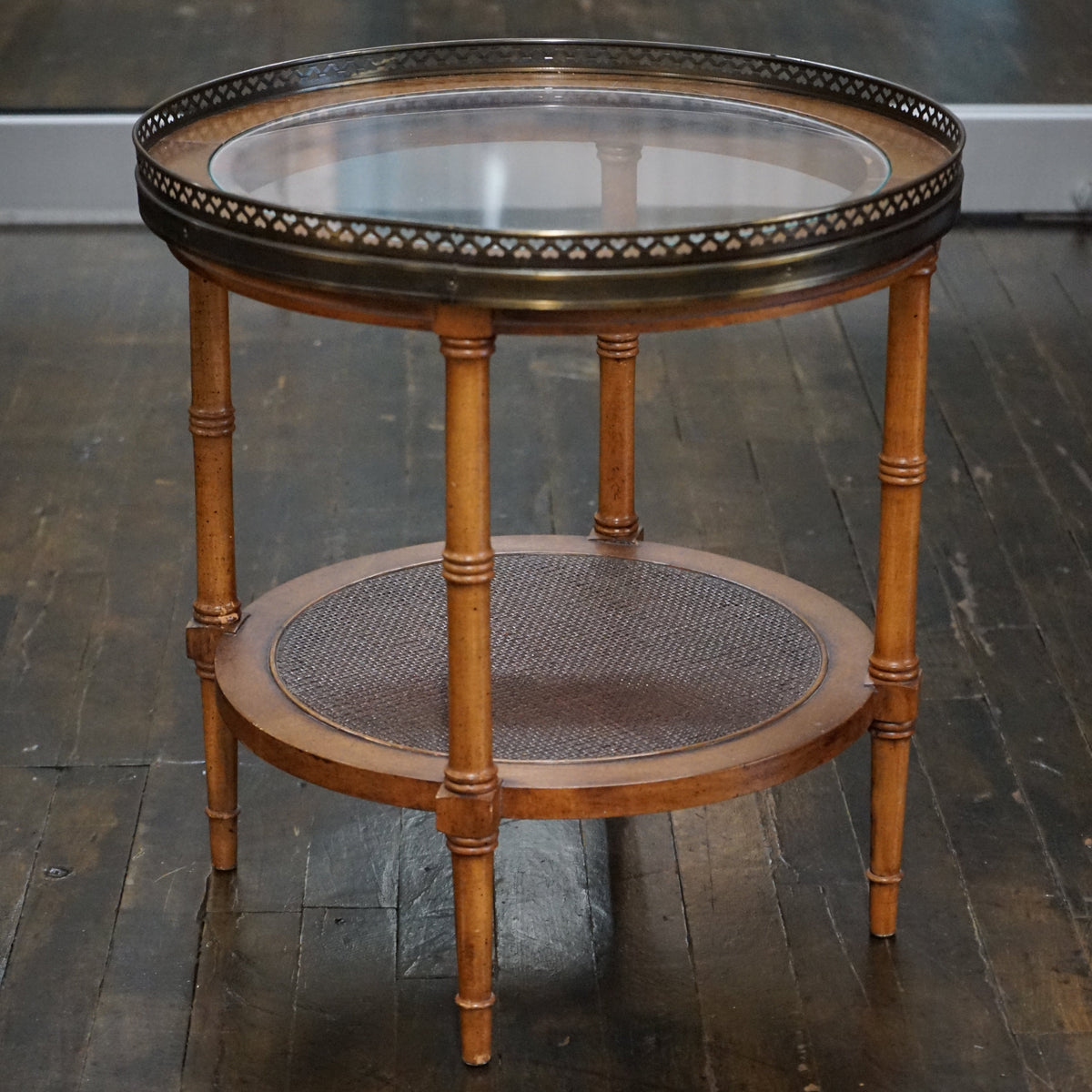 Midcentury accent table that has faux bamboo legs, a glass insert at the top, a lovely pierced metal trim detail.  Faux bamboo legs, cane shelf.  chicago