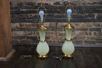Lovely pair of Paul Hanson bronze mounted Vaseline glass lamps done in the Hollywood Regency style. The glass is almost a chartreuse color 