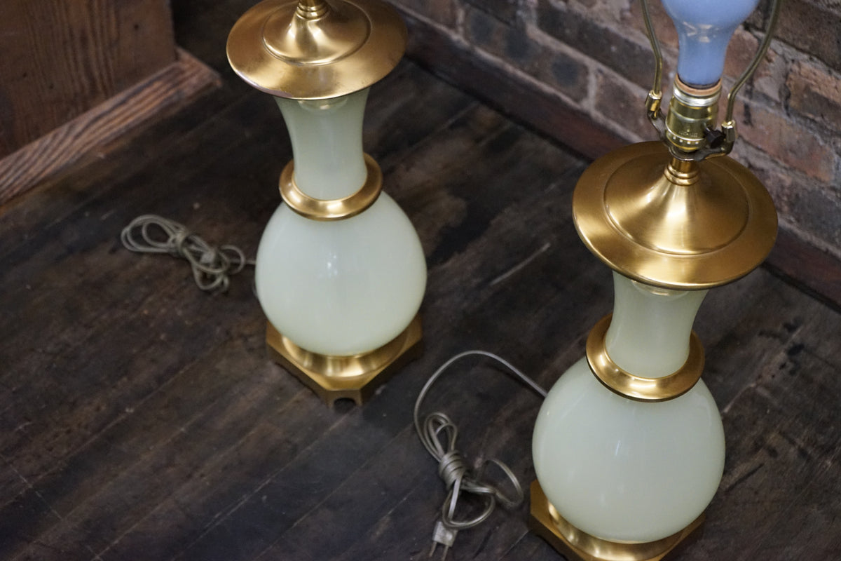 Lovely pair of Paul Hanson bronze mounted Vaseline glass lamps done in the Hollywood Regency style. The glass is almost a chartreuse color 