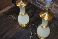 Lovely pair of Paul Hanson bronze mounted Vaseline glass lamps done in the Hollywood Regency style. The glass is almost a chartreuse color 