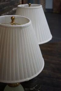 Lovely pair of Paul Hanson bronze mounted Vaseline glass lamps done in the Hollywood Regency style. The glass is almost a chartreuse color 