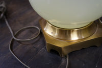 Lovely pair of Paul Hanson bronze mounted Vaseline glass lamps done in the Hollywood Regency style. The glass is almost a chartreuse color 