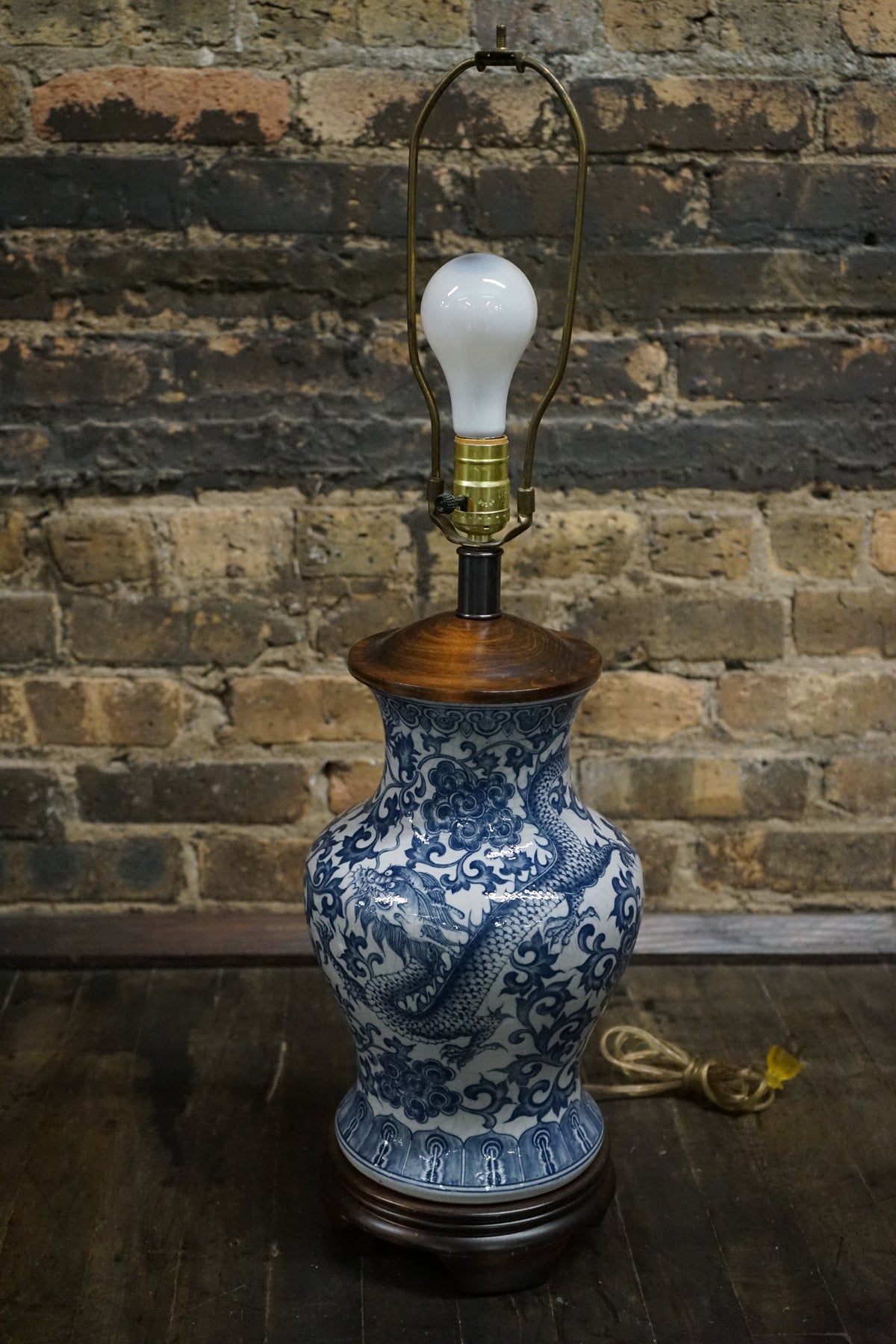 Beautiful blue and white ginger jar lamp by Frederick Cooper. The lamp has an Asian motif painted in the body and it features a dragon.