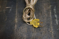 Yellow electrical plug on a textured dark surface