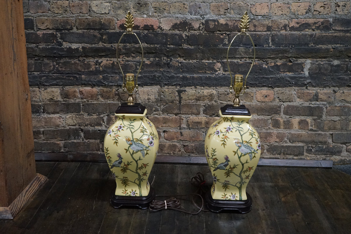 Lovely pair of matching hand painted ceramic lamps from Bradburn.  They have a yellow field and hand painted birds and greenery.