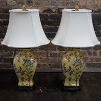 Lovely pair of matching hand painted ceramic lamps from Bradburn.  They have a yellow field and hand painted birds and greenery.