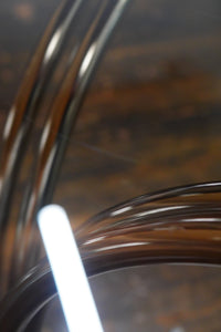 A mid-century modern bistro table with a chrome base and smoke glass top (that is 36" round). Chicago, IL Studio Sonja Milan