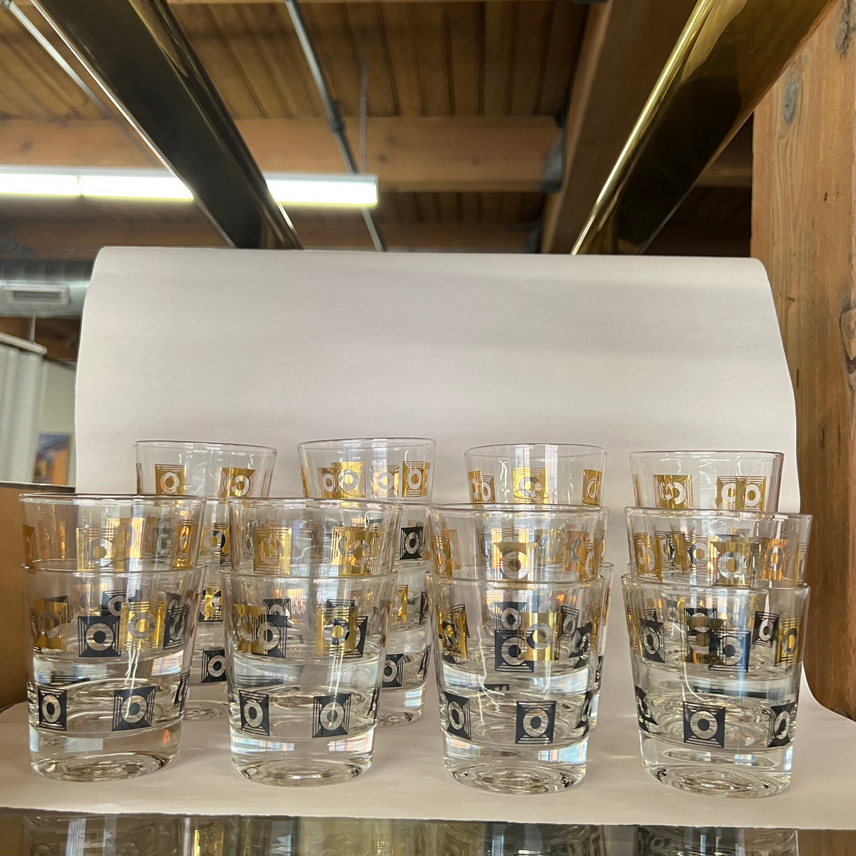 Stunning set of 20 rocks glasses with black and gold motif. Gilding in excellent condition. Almost no wear.No chips. Would be a great and unique addition to a bar. Excellent one-of-a-kind wedding gift. mid-century barware.  Studio Sonja Milan, Chicago.  vintage barware.  Black and gold rocks glasses.