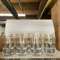 Stunning set of 20 rocks glasses with black and gold motif. Gilding in excellent condition. Almost no wear.No chips. Would be a great and unique addition to a bar. Excellent one-of-a-kind wedding gift. mid-century barware.  Studio Sonja Milan, Chicago.  vintage barware.  Black and gold rocks glasses.