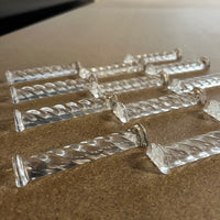 Set of 12 never used, boxed, crystal knife rests circa 1950's - 1960's.  Crystal Au Plomb - 24% PBO.  Bottom of the box is marked Kestarto.  These feature a lovely rolling pattern.  These beauties would make a great unique wedding gift.