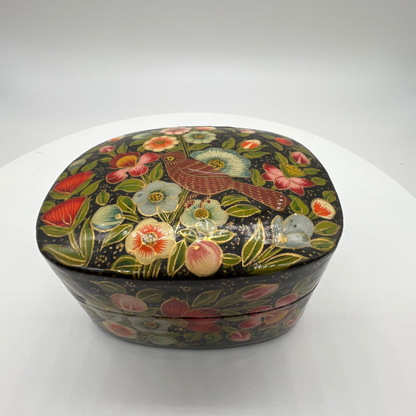 Lovely and finely detailed hand-painted Kashmiri paper cache trinket box. Features flowers, leaves and a bird on a black background.All sides and top of box are painted. 