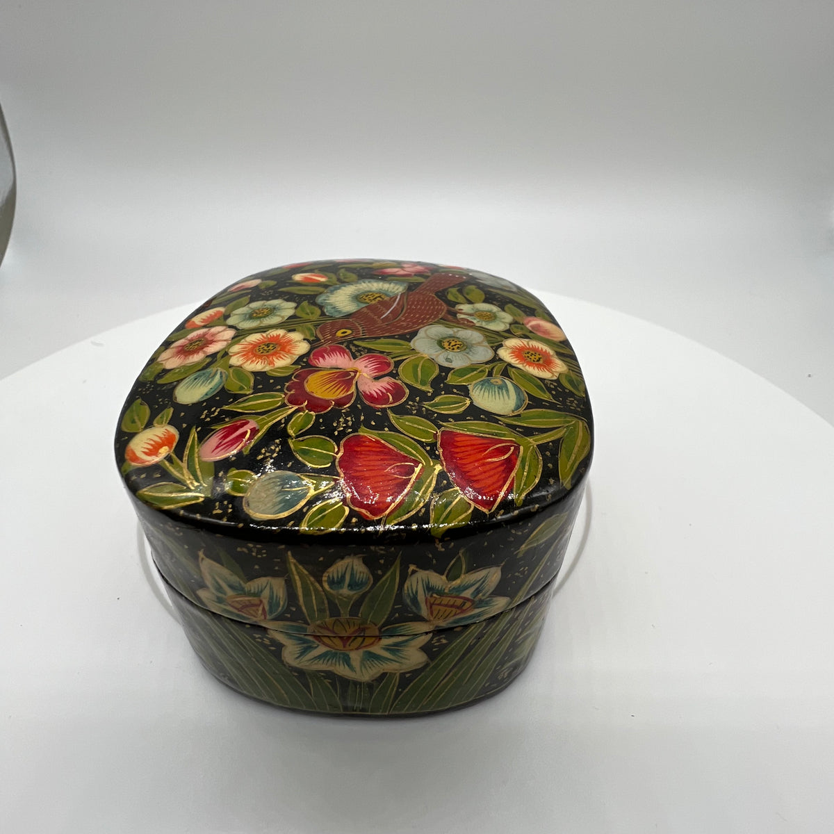 Lovely and finely detailed hand-painted Kashmiri paper cache trinket box. Features flowers, leaves and a bird on a black background.All sides and top of box are painted. 