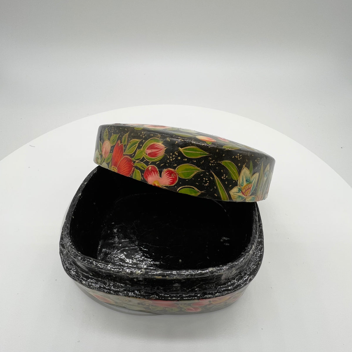 Lovely and finely detailed hand-painted Kashmiri paper cache trinket box. Features flowers, leaves and a bird on a black background.All sides and top of box are painted. 