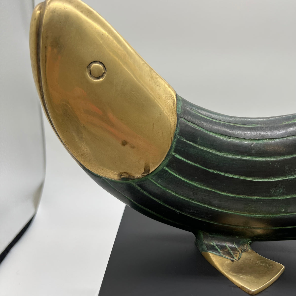 This is a beautiful modern brass and metal fish statue mounted on a stand made by Dolbi Cashier in 1990. Dolbi Cashier produced high-end decorative objects which were designed by owner Ed Schulman.  Lovely modern fish sculpture. Coastal Decor