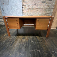 Mid-century executive floating top desk by H.P. Hansen manufactured in Demark circa 1970s. This beautiful desk was made of the highest quality teak.  The back of the desk is completely finished and has one inset opening that can be used for book storage or to display decorative items. STUDIO SONJA MILAN, Chicago, IL