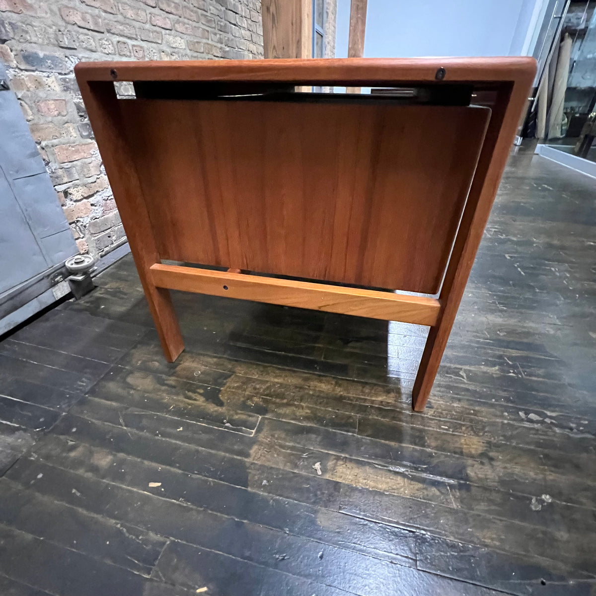 Mid-century executive floating top desk by H.P. Hansen manufactured in Demark circa 1970s. This beautiful desk was made of the highest quality teak.  The back of the desk is completely finished and has one inset opening that can be used for book storage or to display decorative items. STUDIO SONJA MILAN, Chicago, IL