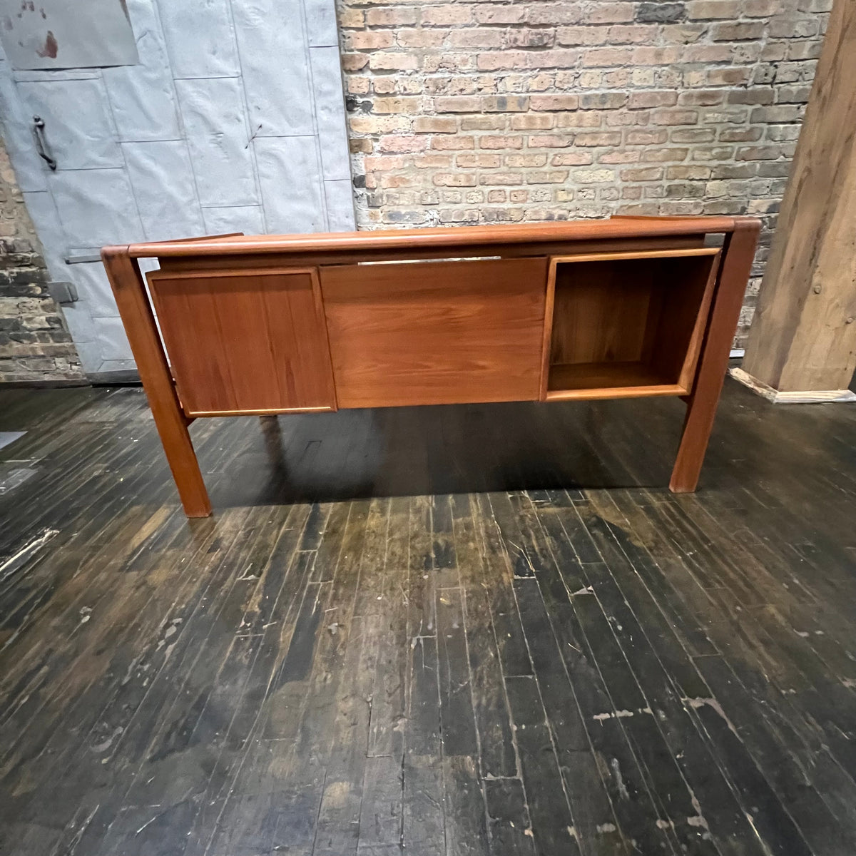 Mid-century executive floating top desk by H.P. Hansen manufactured in Demark circa 1970s. This beautiful desk was made of the highest quality teak.  The back of the desk is completely finished and has one inset opening that can be used for book storage or to display decorative items. STUDIO SONJA MILAN, Chicago, IL