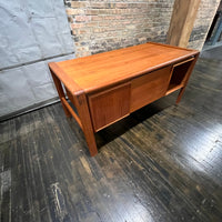 Mid-century executive floating top desk by H.P. Hansen manufactured in Demark circa 1970s. This beautiful desk was made of the highest quality teak.  The back of the desk is completely finished and has one inset opening that can be used for book storage or to display decorative items. STUDIO SONJA MILAN, Chicago, IL