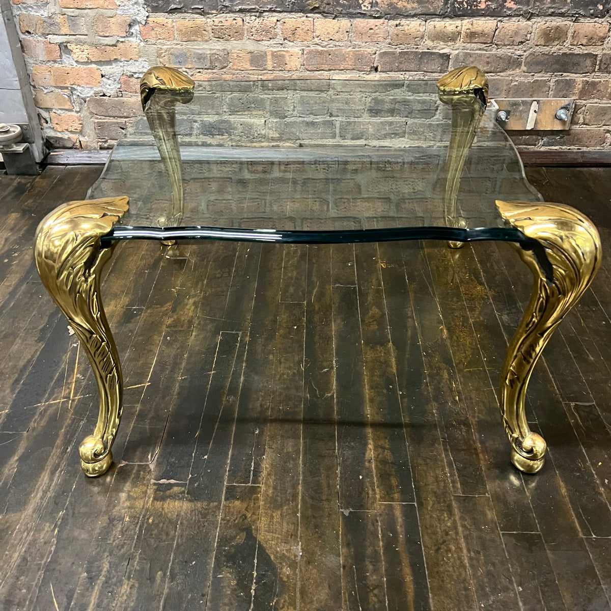 Lovely mid-century side table  with 4 brass legs that support a floating fluted glass top.  In the style and manner of Maison Jansen and P.E. Guerin