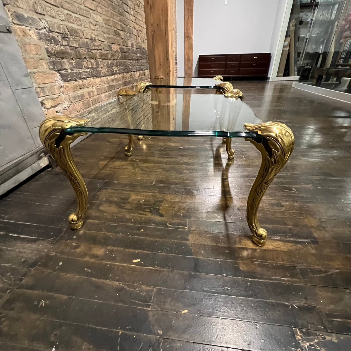 Lovely mid-century side table  with 4 brass legs that support a floating fluted glass top.  In the style and manner of Maison Jansen and P.E. Guerin