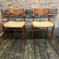  Pair of Niels Møller Model 55 captain's chairs in teak have Danish cord seats and beautifully sculpted teak arms that appear to float off the central frame