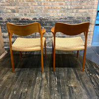 Pair of Niels Møller Model 55 captain's chairs in teak have Danish cord seats and beautifully sculpted teak arms that appear to float off the central frame