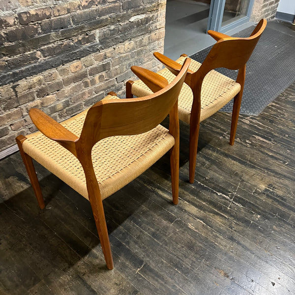 Pair of Niels Møller Model 55 captain's chairs in teak have Danish cord seats and beautifully sculpted teak arms that appear to float off the central frame