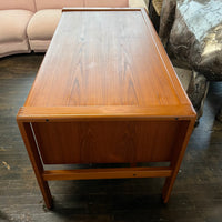 Mid-century executive floating top desk by H.P. Hansen manufactured in Demark circa 1970s. This beautiful desk was made of the highest quality teak.  The back of the desk is completely finished and has one inset opening that can be used for book storage or to display decorative items. STUDIO SONJA MILAN, Chicago, IL