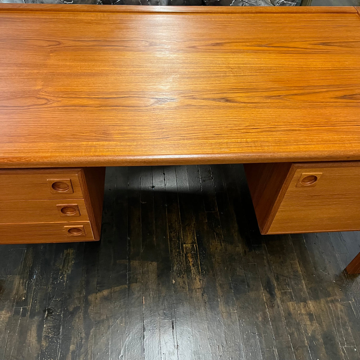 Mid-century executive floating top desk by H.P. Hansen manufactured in Demark circa 1970s. This beautiful desk was made of the highest quality teak.  The back of the desk is completely finished and has one inset opening that can be used for book storage or to display decorative items. STUDIO SONJA MILAN, Chicago, IL