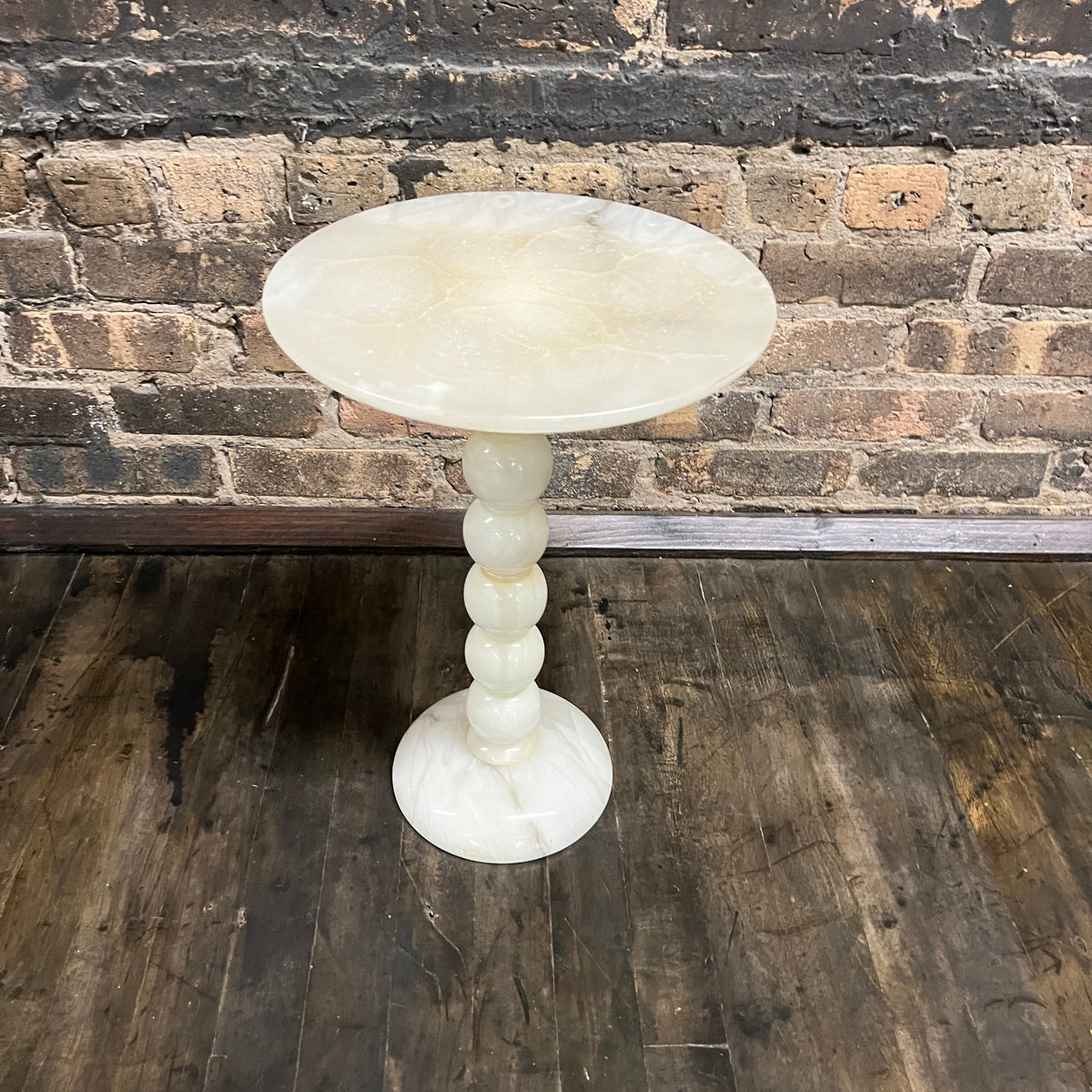 Lovely petite natural stone mid-century cocktail or drinks table.  It has a round base and a bobbin style support with a round table top.   It is primarily off-white with gray and some gold.  It is lovely.  No chips.  11.75" diameter.  Studio Sonja Milan, Chicago, IL Mid-century modern Furniture Chicago