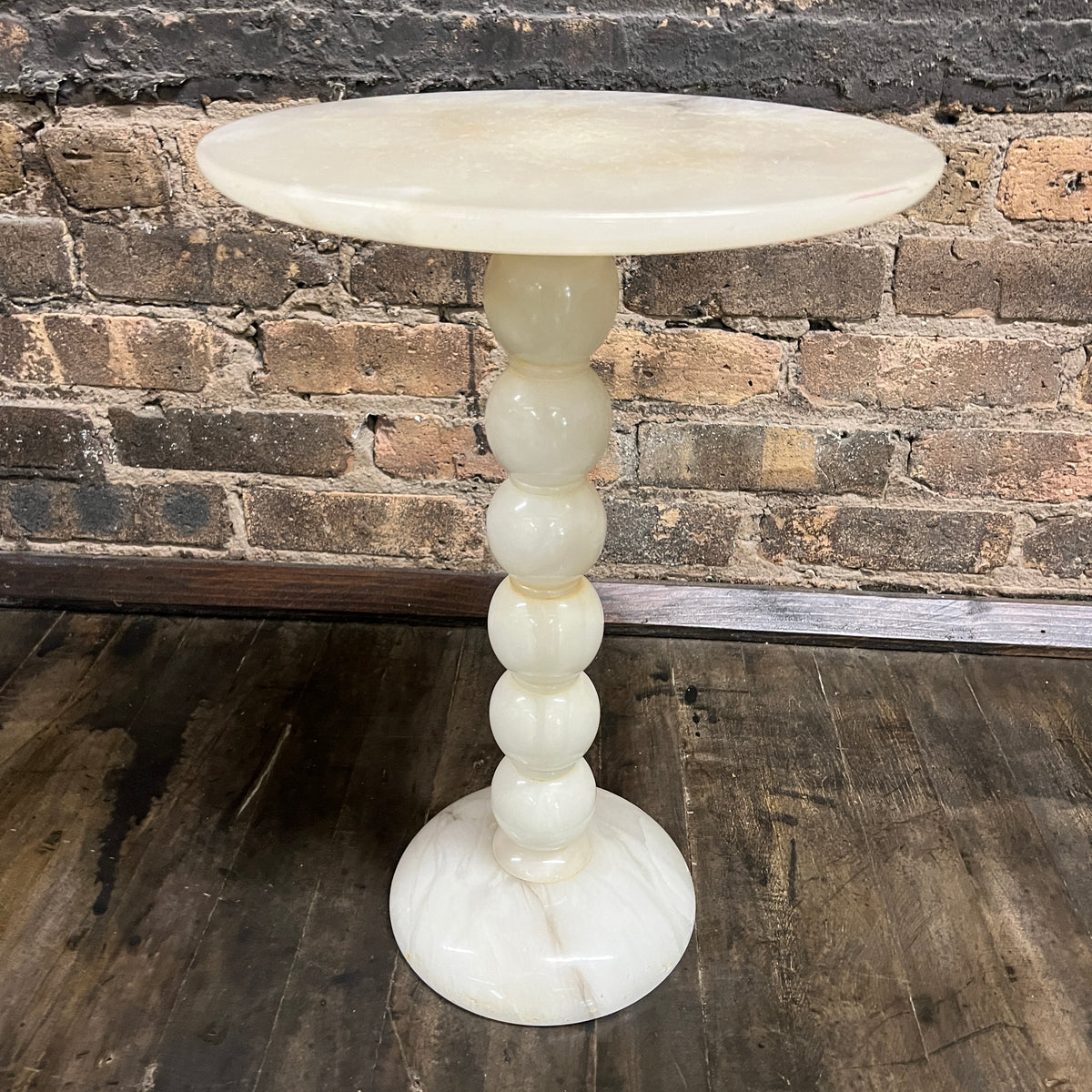 Lovely petite natural stone mid-century cocktail or drinks table.  It has a round base and a bobbin style support with a round table top.   It is primarily off-white with gray and some gold.  It is lovely.  No chips.  11.75" diameter.  Studio Sonja Milan, Chicago, IL Mid-century modern Furniture Chicago