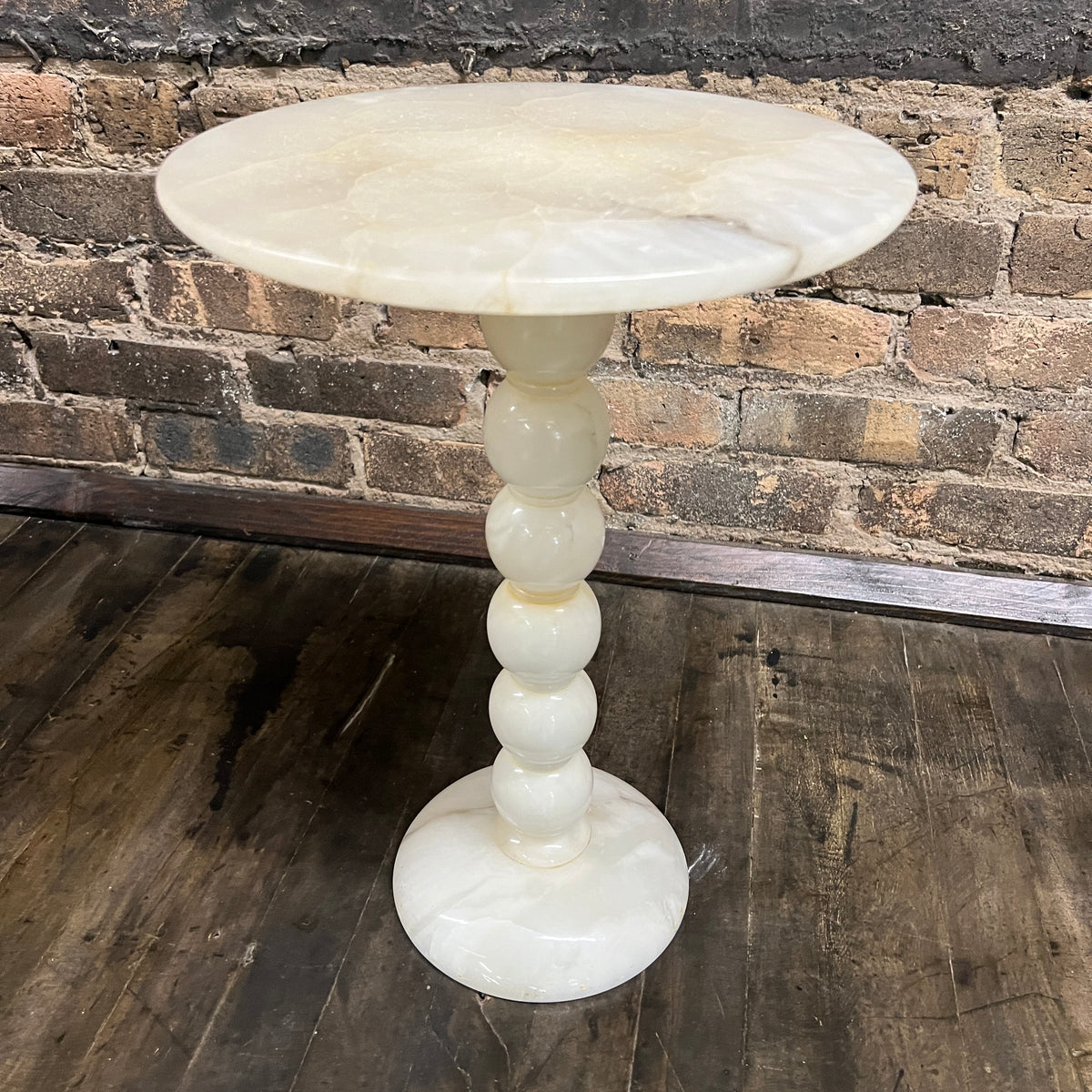 Lovely petite natural stone mid-century cocktail or drinks table.  It has a round base and a bobbin style support with a round table top.   It is primarily off-white with gray and some gold.  It is lovely.  No chips.  11.75" diameter.  Studio Sonja Milan, Chicago, IL Mid-century modern Furniture Chicago