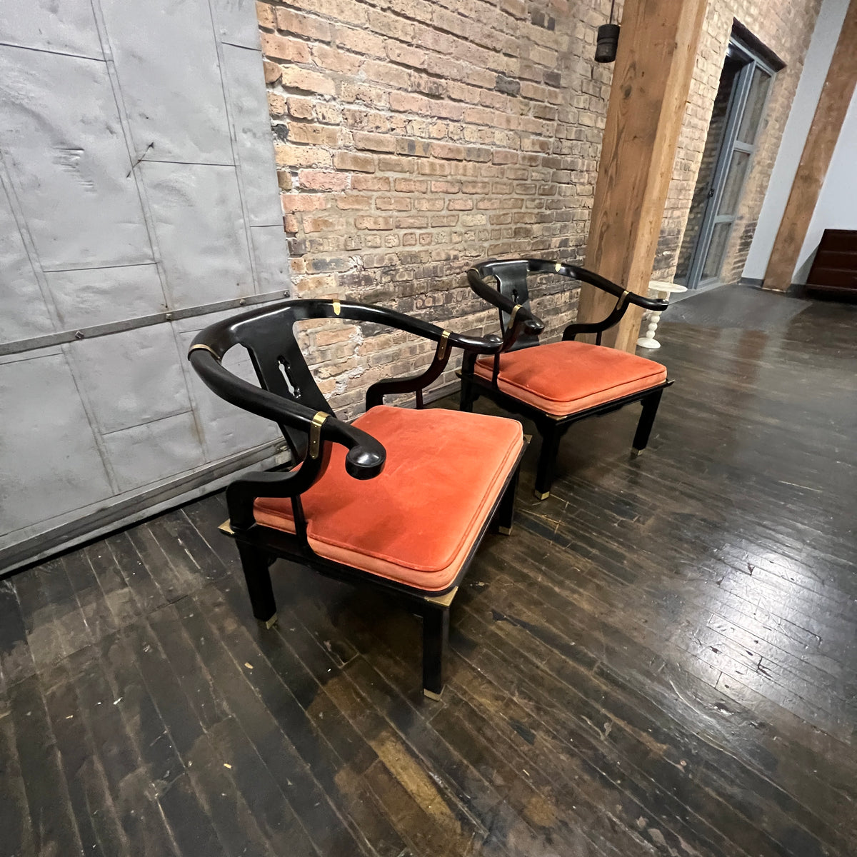 A lovely pair of large Chinese ming style horseshoe lounge chairs made by Century Furniture. Originally designed by James Mont these chairs epitomize his over the top dramatic mid-century modern style with a unique Asian flare. 