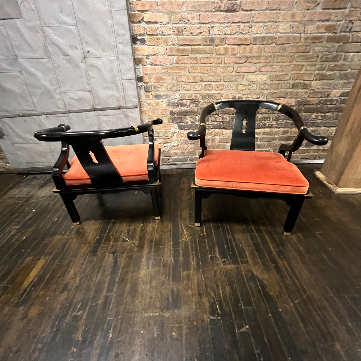 A lovely pair of large Chinese ming style horseshoe lounge chairs made by Century Furniture. Originally designed by James Mont these chairs epitomize his over the top dramatic mid-century modern style with a unique Asian flare. 
