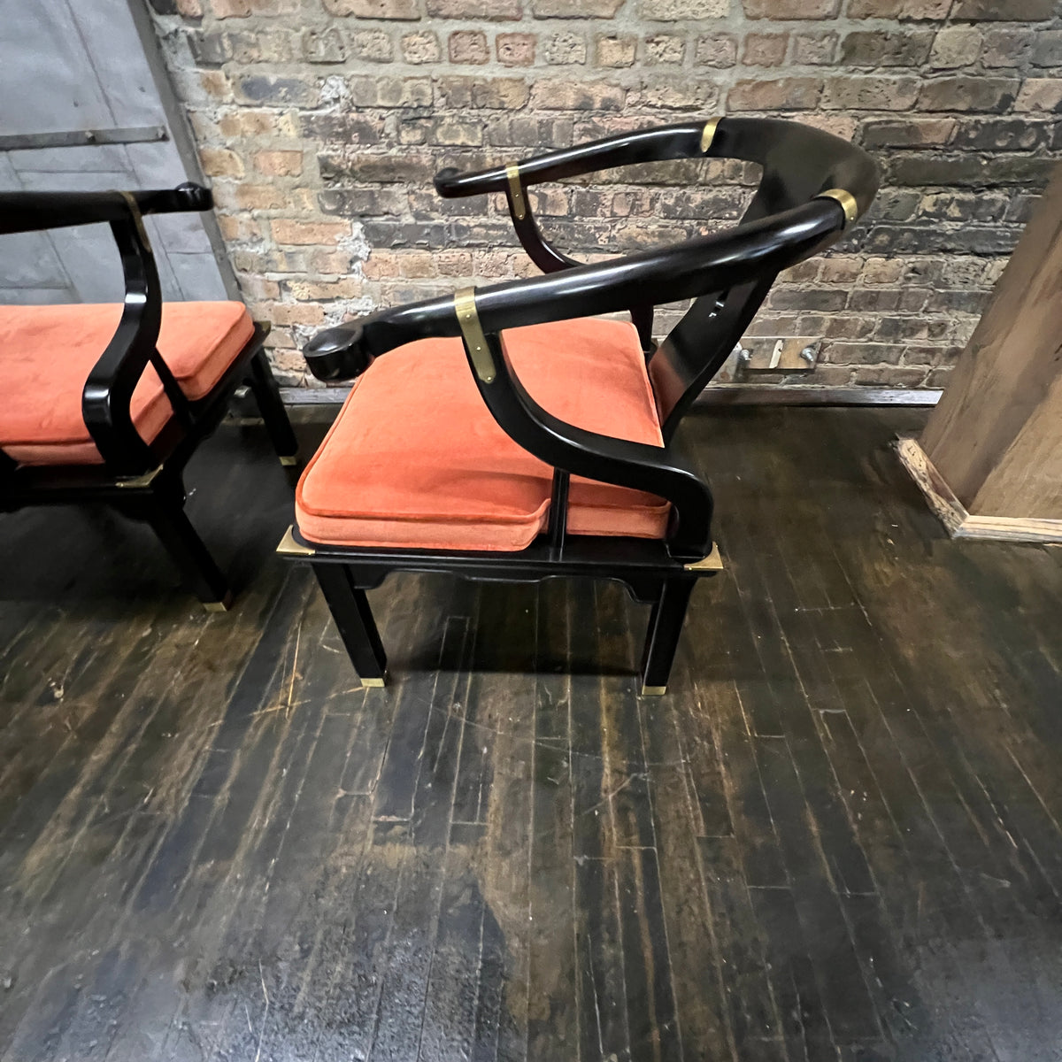 A lovely pair of large Chinese ming style horseshoe lounge chairs made by Century Furniture. Originally designed by James Mont these chairs epitomize his over the top dramatic mid-century modern style with a unique Asian flare. 