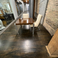 Stunning and unique mid-century dining table by Baker Furniture that features a rich brown wood top and triangular shaped polished chrome legs. Studio Sonja Milan, Chicago, IL