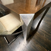 Stunning and unique mid-century dining table by Baker Furniture that features a rich brown wood top and triangular shaped polished chrome legs. Studio Sonja Milan, Chicago, IL