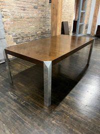 Stunning and unique mid-century dining table by Baker Furniture that features a rich brown wood top and triangular shaped polished chrome legs. Studio Sonja Milan, Chicago, IL