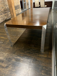 Stunning and unique mid-century dining table by Baker Furniture that features a rich brown wood top and triangular shaped polished chrome legs. Studio Sonja Milan, Chicago, IL