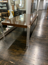 Stunning and unique mid-century dining table by Baker Furniture that features a rich brown wood top and triangular shaped polished chrome legs. Studio Sonja Milan, Chicago, IL