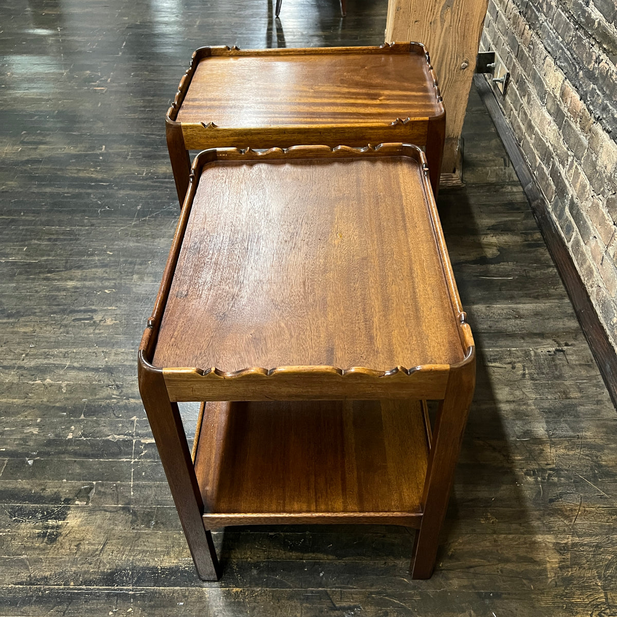 Lovely pair of scalloped edge side tables that appear to be English walnut. They have soft curves, a lower level and amazing patina. Chicago, IL Studio Sonja Milan