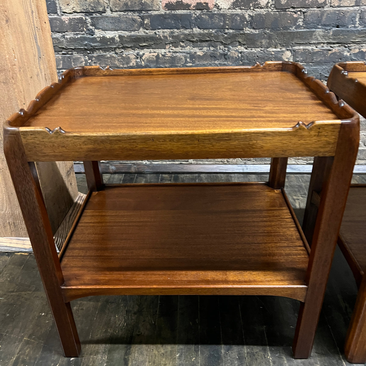 Lovely pair of scalloped edge side tables that appear to be English walnut. They have soft curves, a lower level and amazing patina. Chicago, IL Studio Sonja Milan