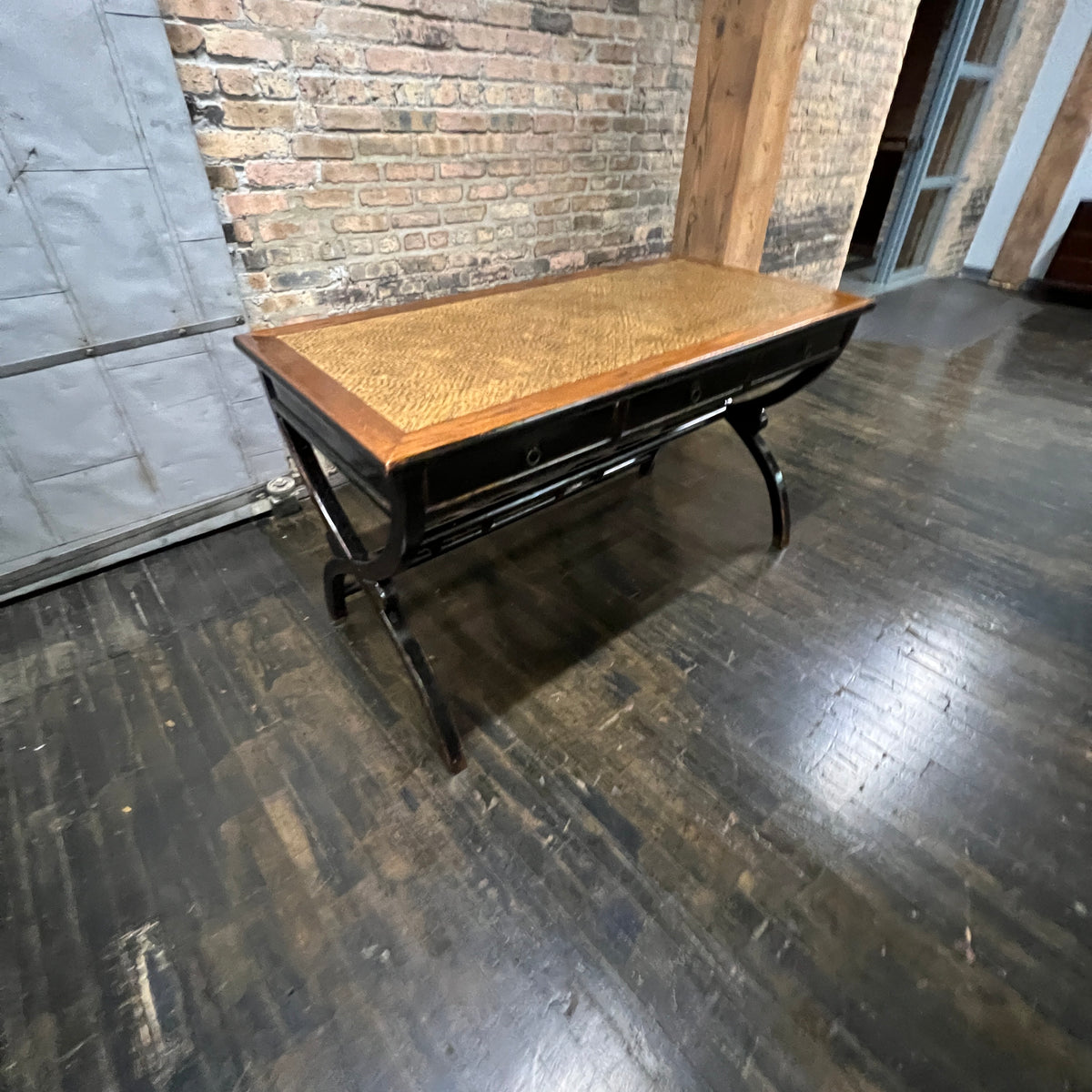 Black lacquer desk that has a smooth rattan inlay on top.  Three drawers.  Chicago, IL Studio Sonja Milan