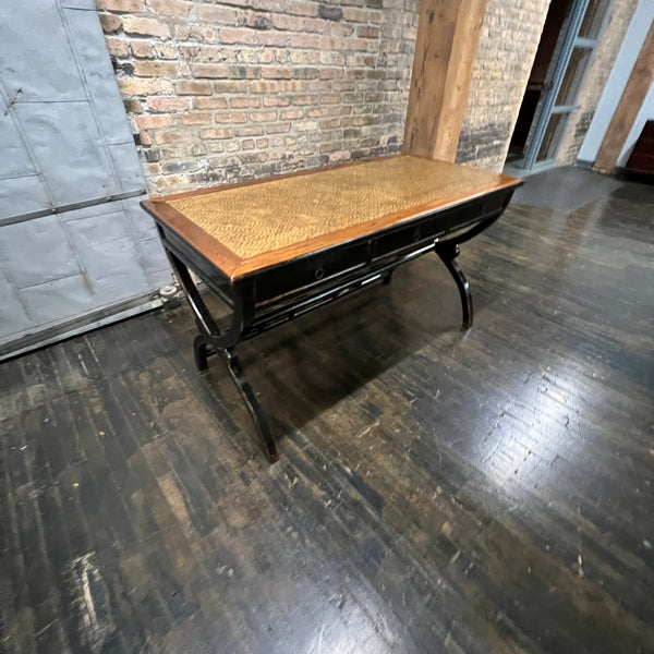 Black lacquer desk that has a smooth rattan inlay on top.  Three drawers.  Chicago, IL Studio Sonja Milan