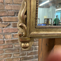 Lovely gilt mirror, one of two available.  At the top of the mirror there is a sheaf of wheat, crescent and laurel leaves at the top and beautiful details at the sides and bottom of the mirror frame.  