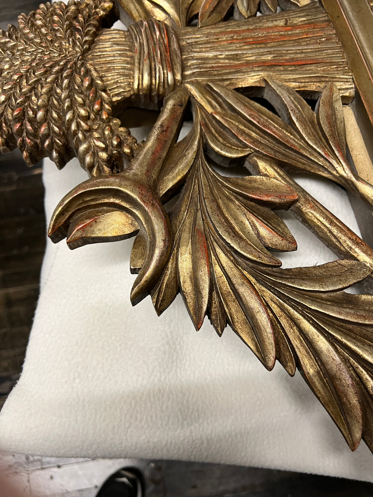 Lovely gilt mirror, one of two available.  At the top of the mirror there is a sheaf of wheat, crescent and laurel leaves at the top and beautiful details at the sides and bottom of the mirror frame.  