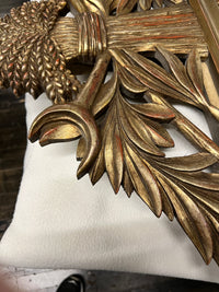 Lovely gilt mirror, one of two available.  At the top of the mirror there is a sheaf of wheat, crescent and laurel leaves at the top and beautiful details at the sides and bottom of the mirror frame.  