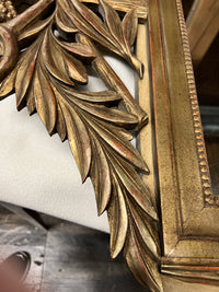 Lovely gilt mirror, one of two available.  At the top of the mirror there is a sheaf of wheat, crescent and laurel leaves at the top and beautiful details at the sides and bottom of the mirror frame.  